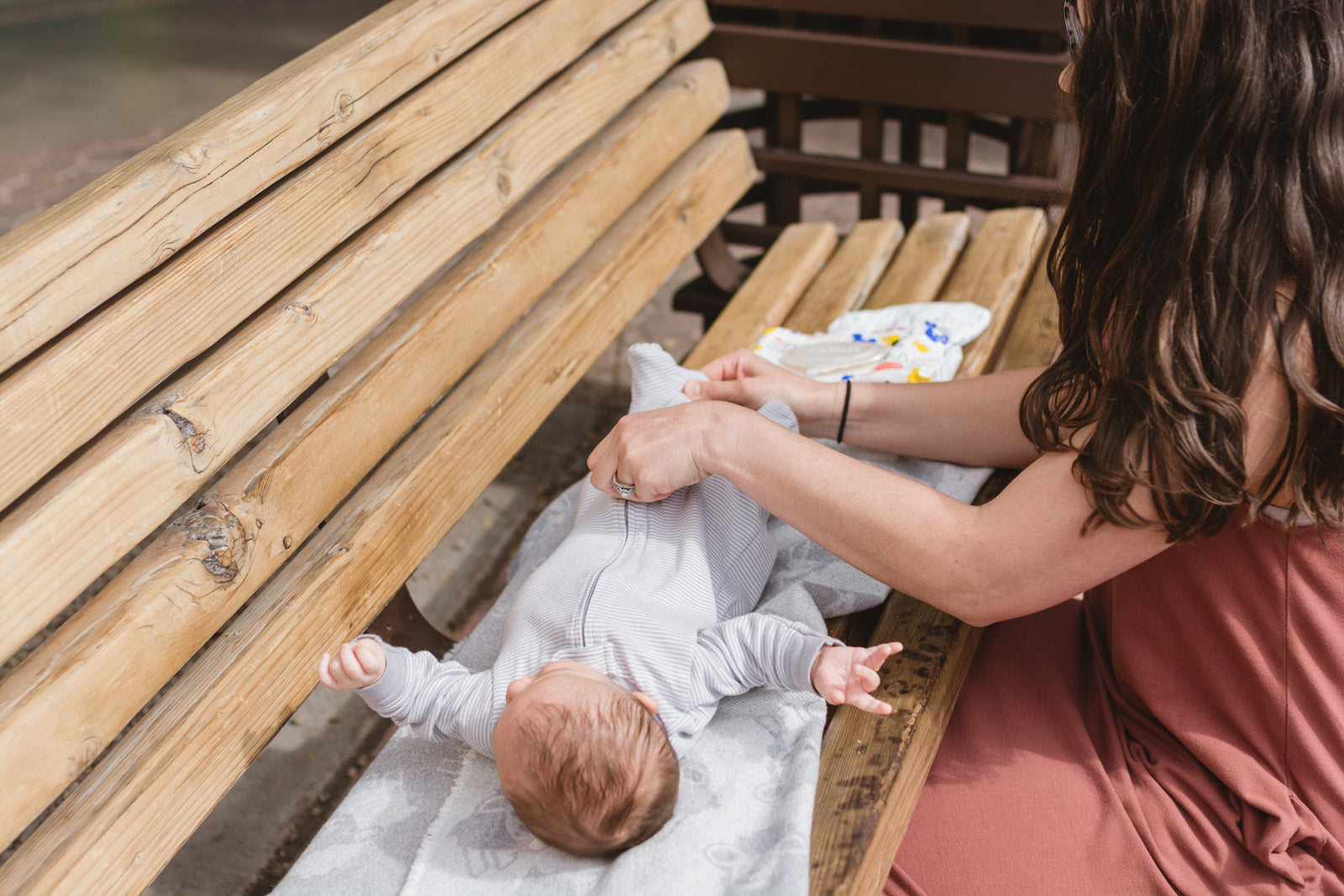 Changing a baby on park bench